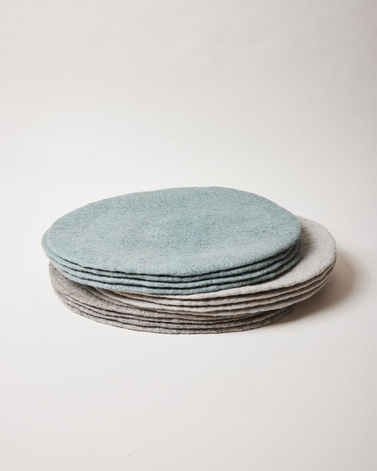 Farmhouse Pottery artisan felt placemats in teal, pebble grey and stone.